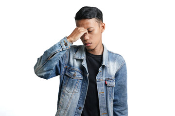 Asian man wearing blue jean jacket has headache or dizzy head. Isolated by white background