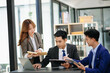 © laddawan - Female discussing new project with male colleague. Mature woman talking with young man in office..
