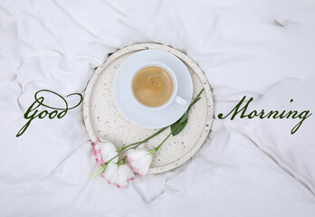 Poster - Good morning! Tray with cup of coffee and flowers on white bedsheet, top view