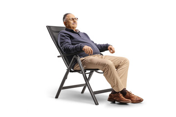 Poster - Mature man resting seated in a foldable chair