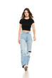 © vladimirfloyd - Young female model wearing ripped jeans and black shirt walking on a white background. Front view