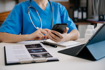 Medical technology concept. Doctor working with mobile phone and stethoscope in office.