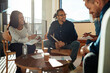 © Flamingo Images - Diverse group of office colleagues laughing together during a meeting