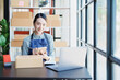 © Jirapong - Starting small business entrepreneur of independent young Asian woman online seller is using computer and taking orders to pack products for delivery to customers. SME delivery concept
