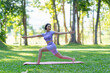 © crizzystudio - Attractive and strong Asian woman with a beautiful body. yoga in graceful posture in the green park Modern concept of relaxation and health care.
