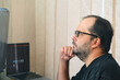 © Cavan - A European man in glasses works at a computer