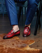 © Elenka Kharichka/Stocksy - Men in red leather mens shoes on calfskin