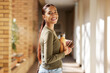 © K.A./peopleimages.com - Woman portrait, university student and college books and water bottle while walking at campus with a smile. Gen z female happy about education, learning and future after studying at school building