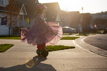 Girl In Long Flowing Dress On A Hoverboard In Driveway 