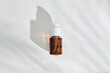 © Marc Tran/Stocksy - Brown bottle with natural organic cosmetic product under the shadow
