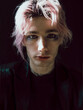 © Ksenia Krondo/Stocksy - Portrait of a cute boy with pink hair and stylish make up