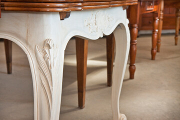 Wall Mural - Detail of an old carved italian wooden table with floral elements just restored