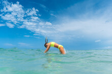 Girl Diving Into Aqua Blue Water