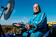 © Ezequiel Giménez/Stocksy - Senior man driving tractor in field