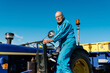 © Ezequiel Giménez/Stocksy - Senior male driver on rural tractor