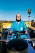 © Ezequiel Giménez/Stocksy - Smiling farmer driving truck in field