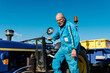 © Ezequiel Giménez/Stocksy - Tractor driver working in sunny field