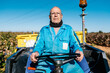 © Ezequiel Giménez/Stocksy - Elderly farm worker driving truck in field