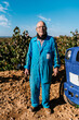 © Ezequiel Giménez/Stocksy - Senior farmer near vehicle on field