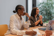 © Milles Studio/Stocksy - Diverse businesswomen sitting at table during meeting