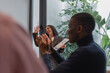 © Milles Studio/Stocksy - Female leader enjoying applauds during meeting