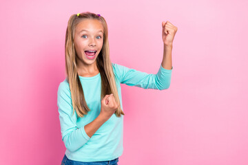 Poster - Closeup photo of young adorable little cute schoolgirl wear cyan shirt open mouth excited good mood fists up celebrate isolated on pink color background