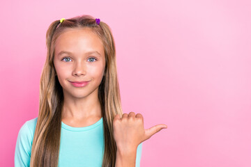 Poster - Closeup photo of young little cute nice girl wear blue pullover positive finger pointing empty space advert shopping isolated on bright pink color background