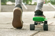 © Cavan Images - Close-up of guy legs in shorts on an outdoor penny skateboard