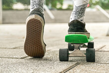 Close-up Of Guy Legs In Shorts On An Outdoor Penny Skateboard