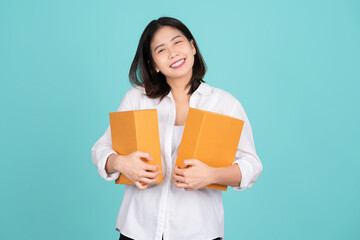 Wall Mural - Young beautiful Asian businesswoman wearing white shirt. She is excited cardboard standing isolated on light green background, courier and courier service.