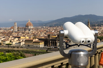 Panoramic view of Florence from the Michelangelo square. Beautiful city of Italy with old buildings and river.  Observing point with a binocular.