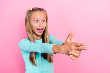 Sticker - Photo of youngster preteen schoolkid girl open mouth reaction fingers pistol weapon excited positive mood shooting isolated on pink color background