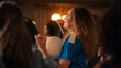 © Gorodenkoff - Portrait of an Excited Young Female in a Blue T-Shirt Standing in a Crowd of Sports Fans in a Bar, Watching TV Broadcast. Fans Celebrating When Team Scores a Goal and Wins the Championship.