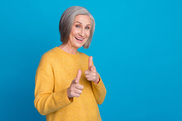 Sticker - Photo portrait of stunning grandma fingers point you cool energetic promoter wear trendy yellow outfit isolated on blue color background