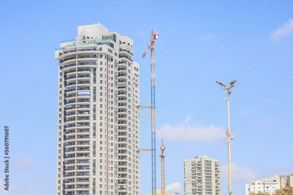 Unfinished building and construction crane on sunny day