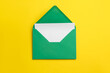 © Pixel-Shot - Green envelope with card on yellow background