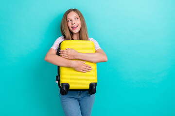 Poster - Portrait of positive minded person hands hold suitcase look empty space isolated on emerald color background