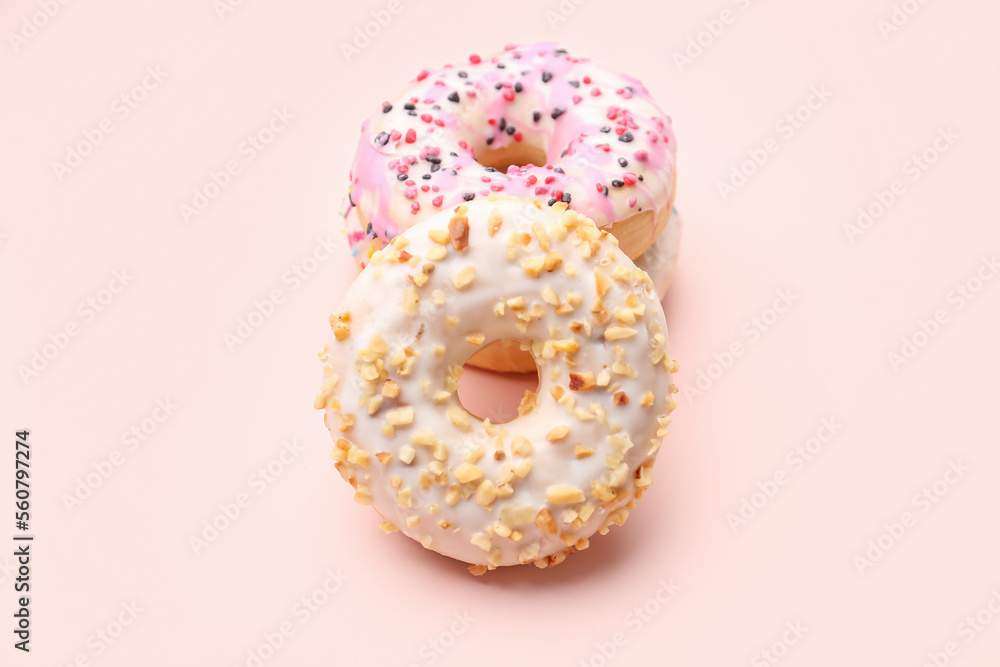 Tasty donuts on pink background