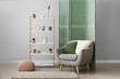 © Pixel-Shot - Interior of living room with shelving unit, armchair and folding screen