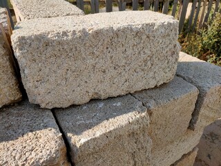 Close-up of a shell brick. Shell construction material. A pile of bricks.