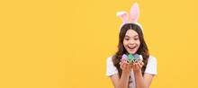 Amazed Kid In Bunny Ears Hold Eggs On Yellow Background. Easter Child Horizontal Poster. Web Banner Header Of Bunny Kid, Copy Space.