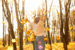 © Татьяна Волкова - Rearview of wonderful, careless blond woman walk in golden forest, collect and throwing oak and maple leaves like rain