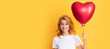 happy redhead woman with red heart balloon. happy valentines day. Beautiful woman isolated face portrait, banner with mock up copy space.