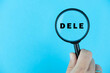 © strigana - Focused on DELE exam. Word DELE (Diploma de Español como Lengua Extranjera) under magnifying glass. Spanish Language Proficiency Test. Test Preparation. E-learning.