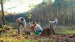 © ihorvsn - Couple of green planet activists planting trees in garden or wood and protecting nature. Outdoors. People working in park with tree seedlings on autumn day. Coworking for environment.