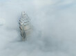 Aerial View Of A Single Commercial Building Peeking Out Of An Early Morning Fog Bank In The American South