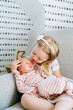 © Cavan Images - Closeup portrait of two sisters sitting together in a rocking chair