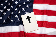 Holy Bible Book With A Black Cross On American Flag