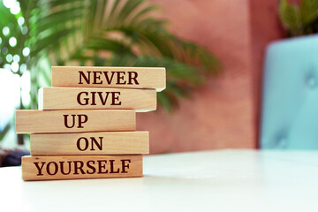 Wooden blocks with words 'Never give up on yourself'