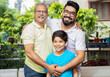 © GAJENDRRA BHATI  - Happy indian senior father standing with his son and grandson smiling looking at camera.